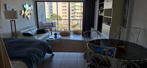 een woonkamer met een bed, een tafel en een bank bij Front de mer Golfe de Saint-Tropez in Sainte-Maxime