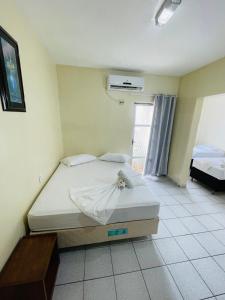 a bedroom with a large bed in a room at Hotel Transbrasil in Belém