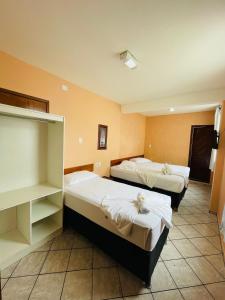 a hotel room with two beds in a room at Hotel Transbrasil in Belém