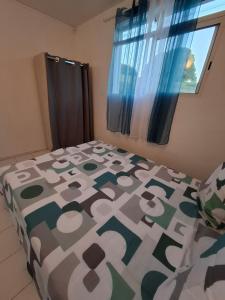 a bedroom with a bed and a window at Logement chaleureux confortable - 2 chambres - Aveline in Petit-Canal