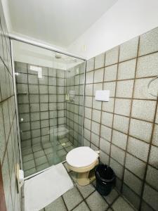 a bathroom with a toilet and a shower at Hotel Transbrasil in Belém +36 photos