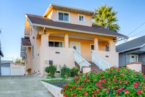 a house with flowers in front of it at 5 Mi to Jack London Square Apt with Shared Yard in Alameda
