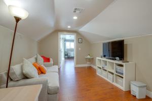 a living room with a couch and a tv at 5 Mi to Jack London Square Apt with Shared Yard in Alameda