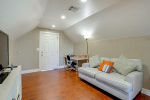a living room with a couch and a desk at 5 Mi to Jack London Square Apt with Shared Yard in Alameda