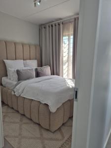 Ένα ή περισσότερα κρεβάτια σε δωμάτιο στο Village Vista at Atlasville 10km from OR Tambo