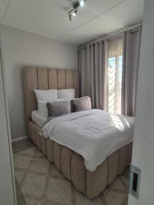 Ένα ή περισσότερα κρεβάτια σε δωμάτιο στο Village Vista at Atlasville 10km from OR Tambo