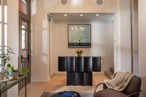 a lobby with a black desk in the middle of a room at Nordoy Hotel - Fattal Colors in Tel Aviv