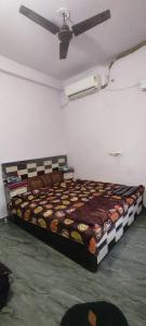a large bed in a room with a ceiling at Jakusst guest house in Gwalior