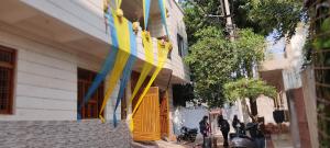 a group of people standing outside of a building at Jakusst guest house in Gwalior