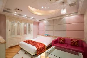 a pink bedroom with a bed and a glass table at HOTEL AN Shinjuku Kabukicho (Adult Only) in Tokyo +29 photos