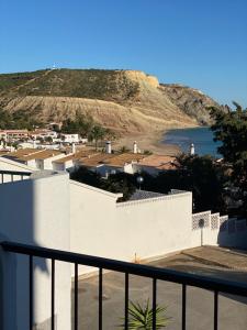 a view from the balcony of a house with a beach at The Ocean View Luz in Luz