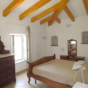 a bedroom with a bed and a dresser and a window at Rosa Di Mare Guest House in Borgio Verezzi