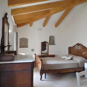 a bedroom with a bed and a wooden dresser at Rosa Di Mare Guest House in Borgio Verezzi +35 photos