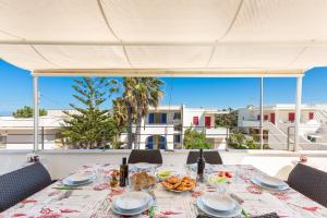 a table with food and a view of a building at Attico Mezzaluna by BarbarHouse in Torre Santa Sabina