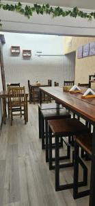a dining room with wooden tables and chairs at EcoHotelTDF in Río Grande +43 photos