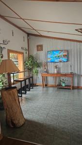 a living room with a table and a tv at EcoHotelTDF in Río Grande