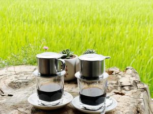 two coffee grinders sitting on top of a tree stump at Expeditions home in Ha Giang +3 photos