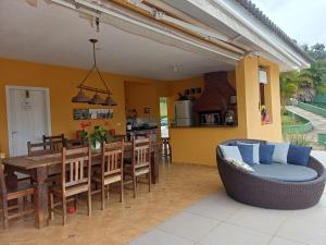 una sala da pranzo e una cucina con tavolo e sedie di Represa de Igaratá Yellow House a Jacareí