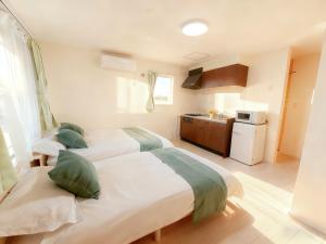 倶知安町にあるNiseko Yotei Vistaのベッドルーム1室(ベッド2台付)、キッチンが備わります。 +12枚の写真