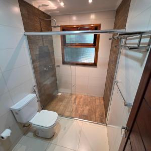 a bathroom with a toilet and a shower at Tupa Lodge Selva y Rio in Puerto Iguazú