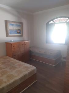 Postel nebo postele na pokoji v ubytování Chácara dos sonhos