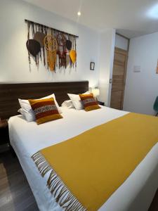 a bedroom with a large bed with a yellow blanket at CASA CRISTOBAL Centenario in Cusco