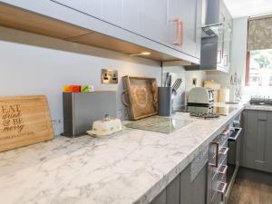 a kitchen with a counter top with a cake on it at Dolly Blue in Ulverston
