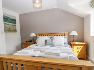 a bedroom with a large bed with white towels on it at Dolly Blue in Ulverston