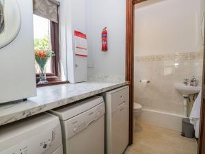 a bathroom with a sink and a toilet at Dolly Blue in Ulverston