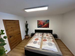 a bedroom with a bed in a room with a door at Ferienappartement Sieger in Großkirchheim