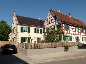 a house with a car parked in front of it at Schlößleweg 2a in Bodman-Ludwigshafen