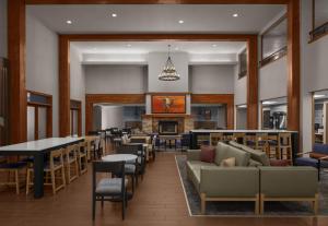 Holiday Inn Express Hotel & Suites Montrose - Black Canyon Area by IHG في مونتروز: مطعم فيه كنب وطاولات وموقد