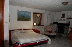 a bedroom with a bed and a fireplace at Case Gran Paradiso Rhemes Saint Georges Vieux in Rhemes-Saint-Georges