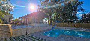 a swimming pool in front of a house at Secret Garden in Grottolella +6 photos
