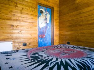 a bedroom with a bed with a painting on the wall at Secret Garden in Grottolella