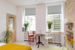 a bedroom with a bed and a table and chairs at The Georgian Studio in Bath
