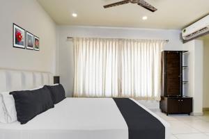 a bedroom with a white bed and a window at 5BHK AC Villa call 8O882 - 37972 in Mysore