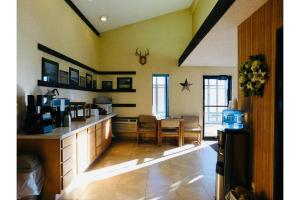 a kitchen with a counter and a dining room at Homestead Inn Wolf Point Hwy 2 in Wolf Point