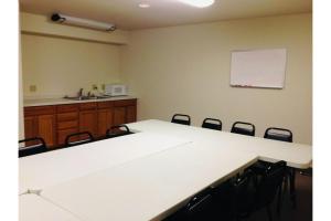 a meeting room with a white table and chairs at Homestead Inn Wolf Point Hwy 2 in Wolf Point