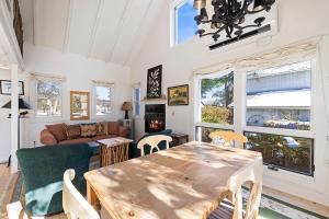 a living room with a table and chairs at Berrywood Cottage in Lakeside