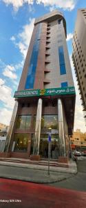 ein hohes Gebäude mit einem Schild an der Vorderseite in der Unterkunft فندق مهوى الفؤاد - المعابدة in An Naqāʼ