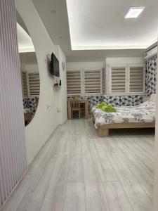 a room with two beds and a television in it at CS Apartment in Skopje