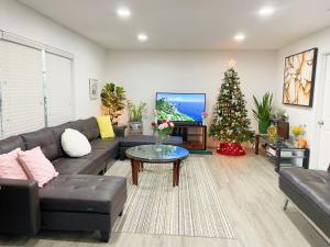 a living room with a couch and a christmas tree at Happy Home in Orlando