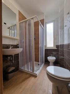 a bathroom with a shower and a toilet and a sink at Hotel Pyramid in Rome +132 photos