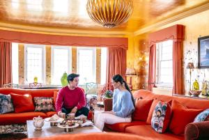 a man and woman sitting in a living room at The Glenmorangie House in Tain