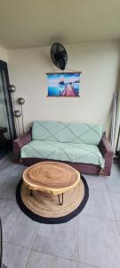 a coffee table in a living room with a couch at Fare Tupaia in Arue