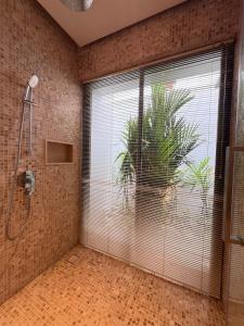 a bathroom with a shower and a large window at Grand garden villa in Phuket +22 photos