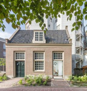 a brick house with a black roof at Wittenberg by Cove in Amsterdam