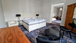 a bedroom with a bed and a table and chairs at Kamienica Bankowa Residence in Poznań