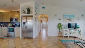 a kitchen with a stainless steel refrigerator at Casa Siwichi in Crystal Beach +20 photos